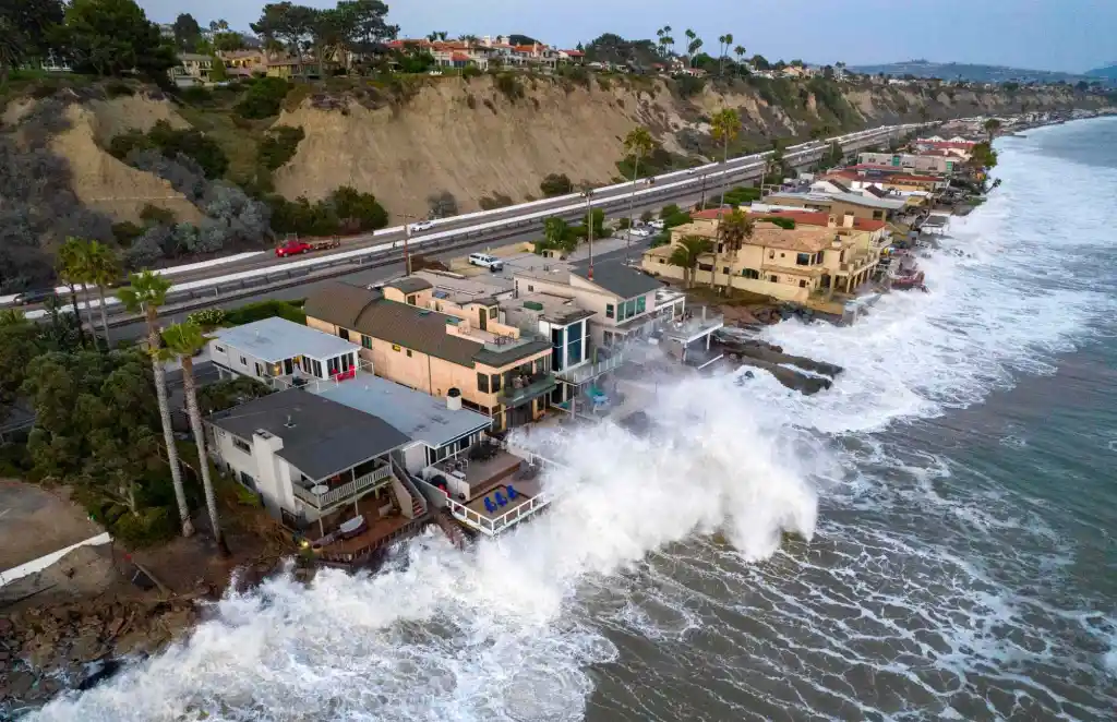 sea hitting houses